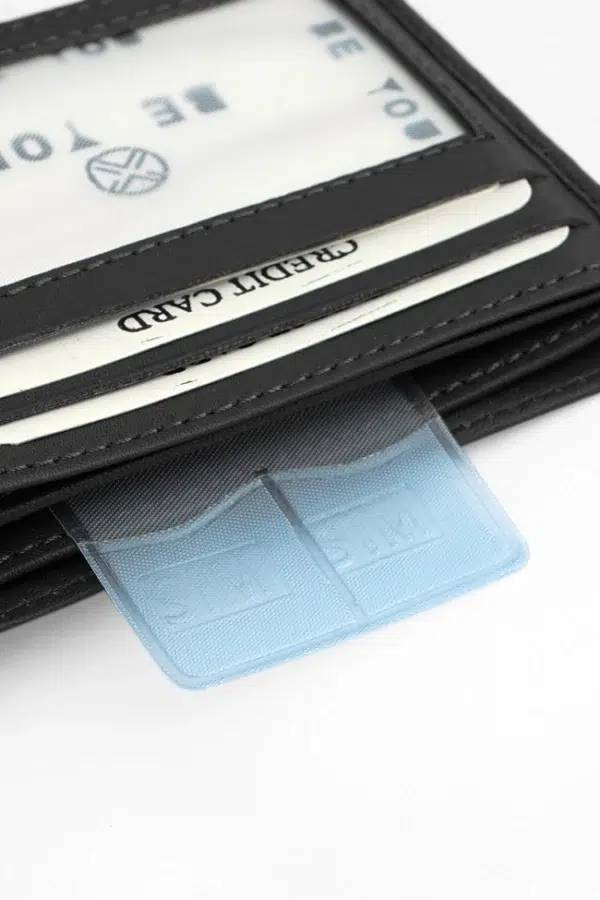 Textured black leather wallet held in hand – slim handmade men’s wallet